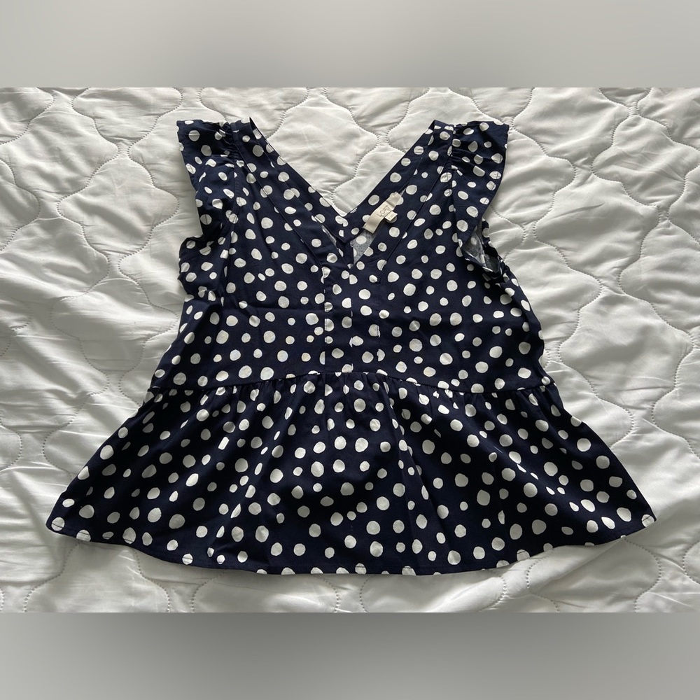 Navy and white polka dot peplum top